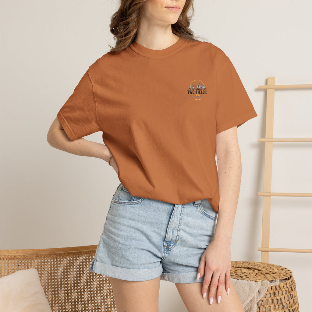Rust brown T-shirt worn by model, featuring small Two Fields Co. chest logo