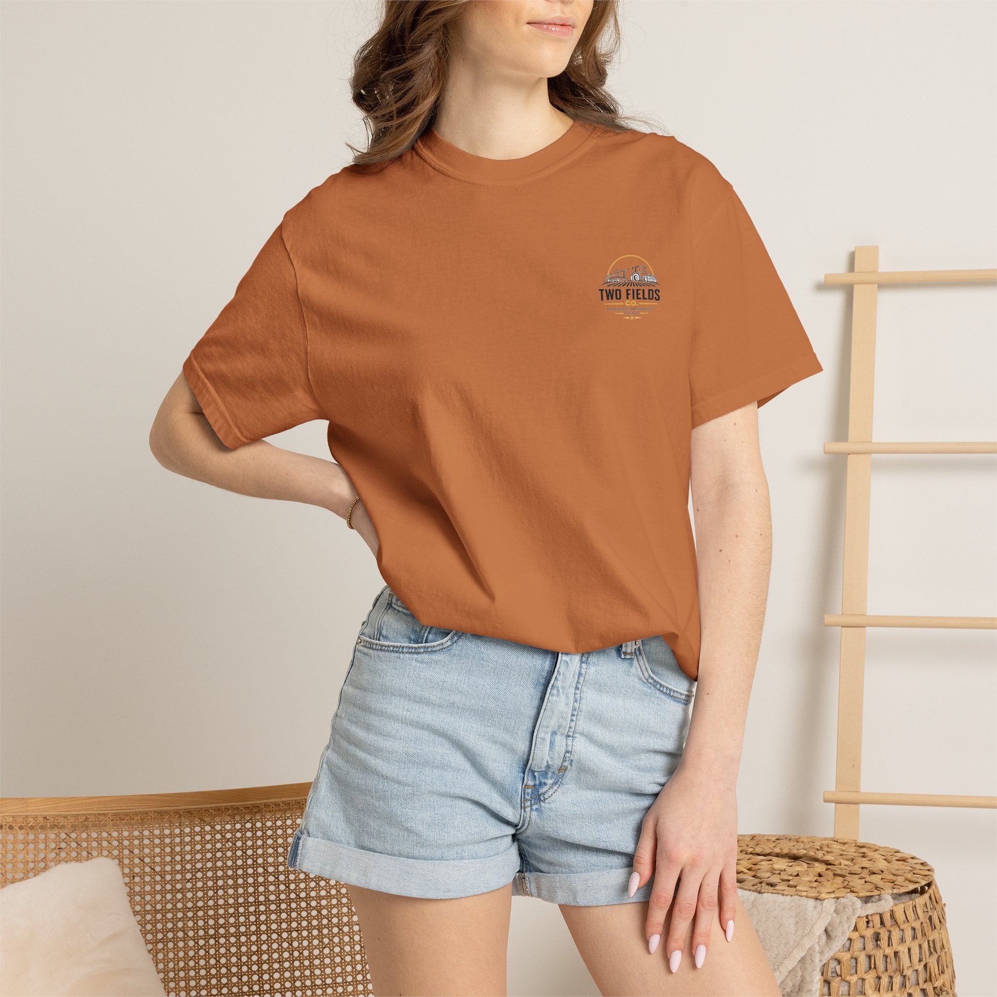Rust brown T-shirt worn by model, featuring small Two Fields Co. chest logo
