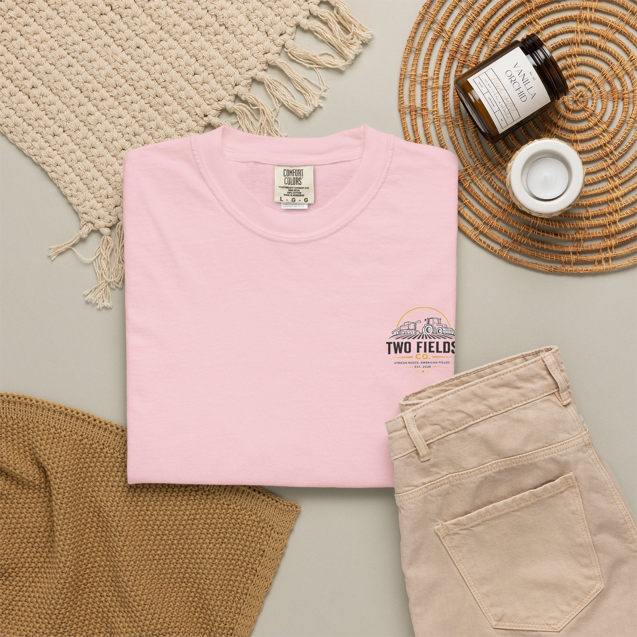 Pink crewneck T-shirt with small Two Fields Co. tractor and family logo