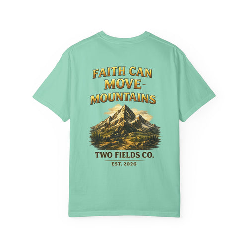 Mint green faith-themed T-shirt with mountain graphic and text on the front.