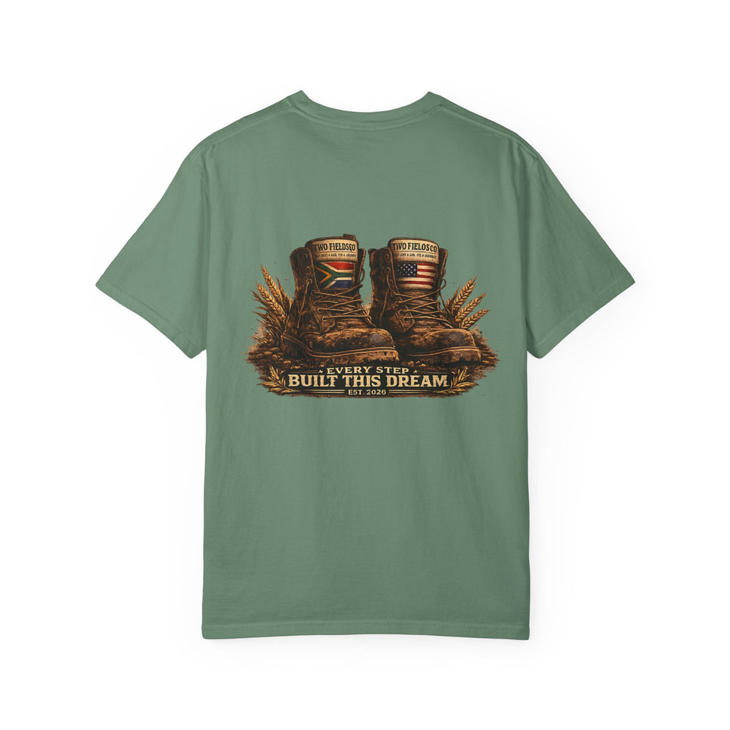 Green T-shirt with boots graphic and 'Every Step Built This Dream' text