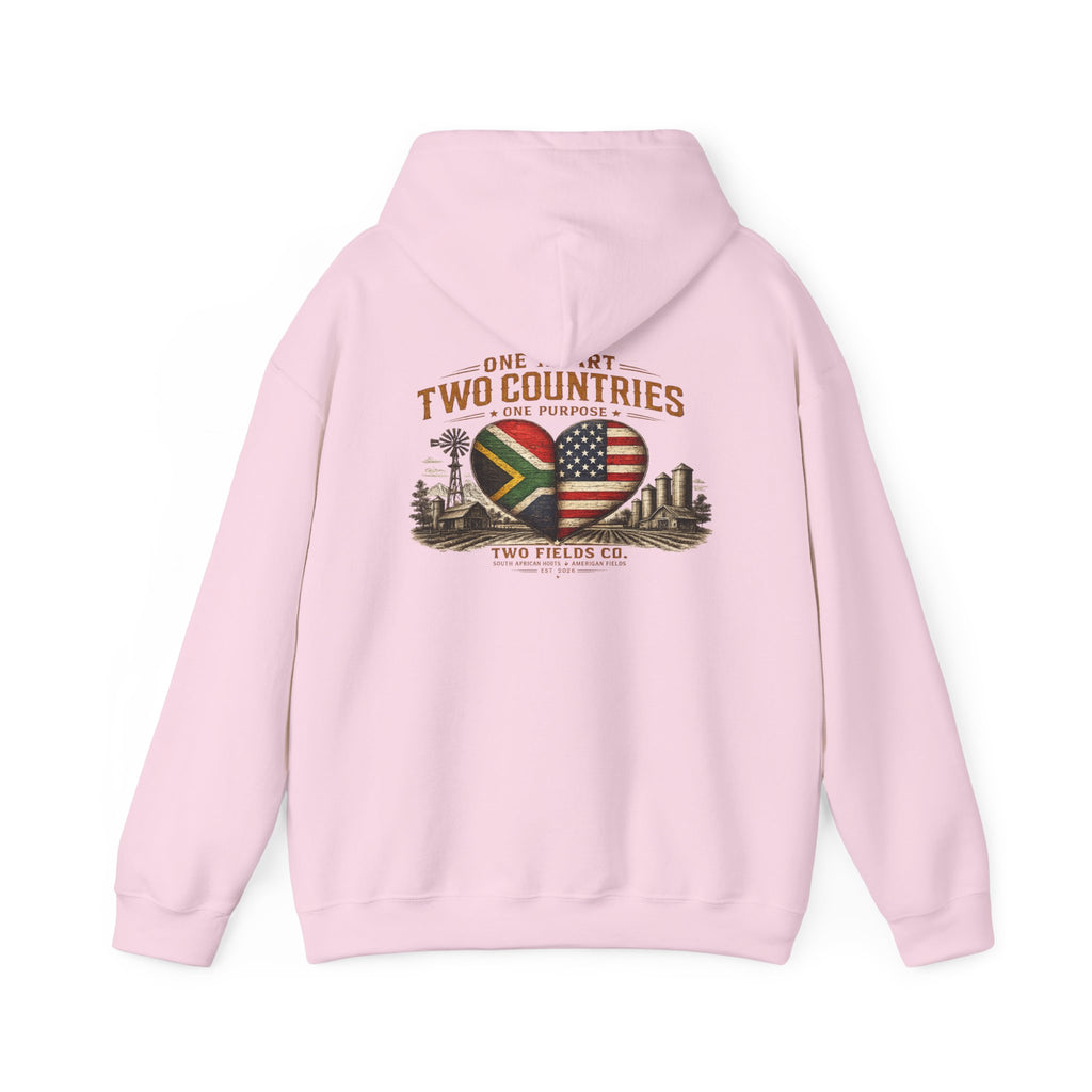 Light pink pullover hoodie with front pouch, drawstring hood, and “One Heart, Two Countries” graphic