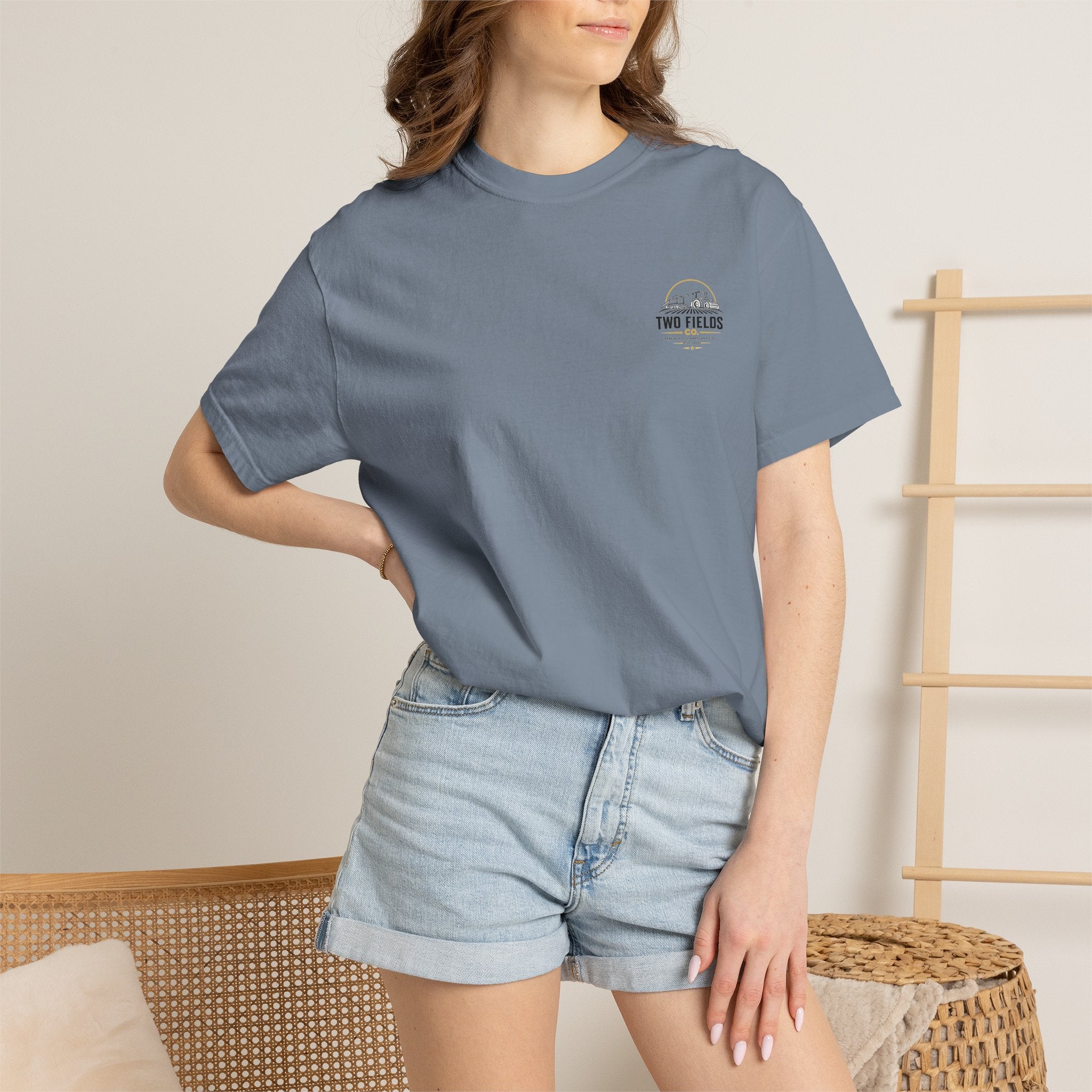 Slate blue T-shirt worn by model; small chest logo graphic
