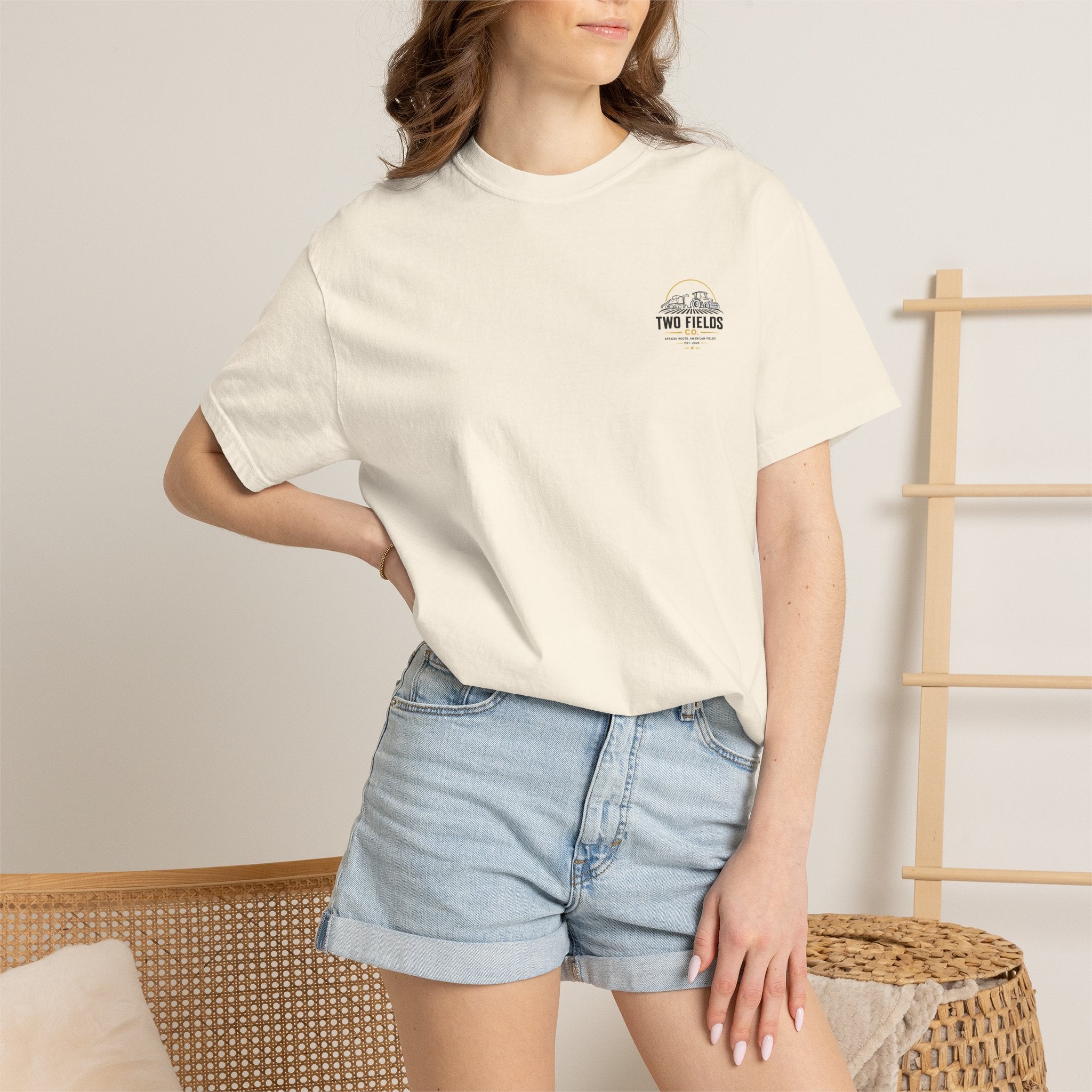Ivory crew-neck graphic t-shirt worn with light denim shorts