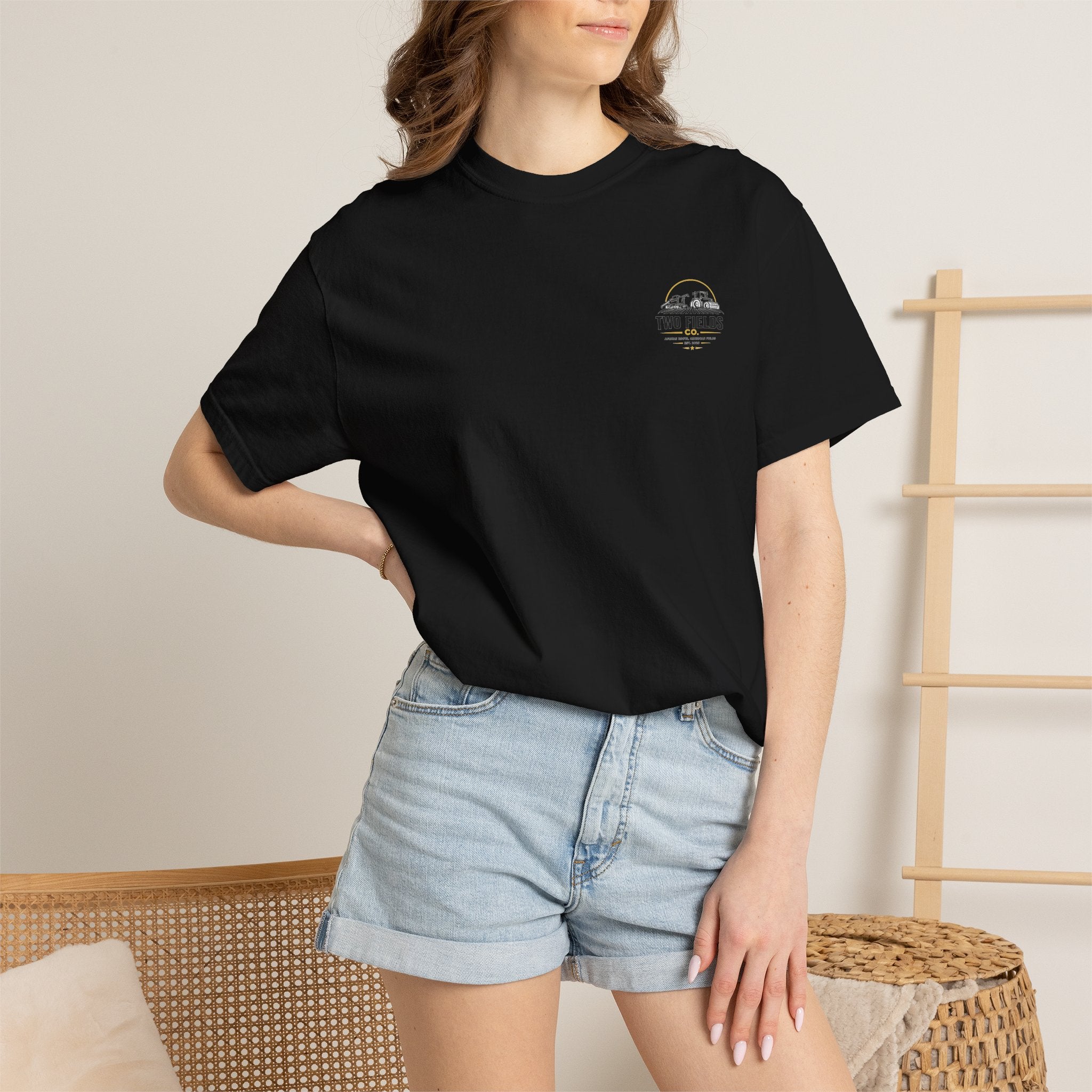 Black T-shirt with small chest Two Fields Co. logo on model