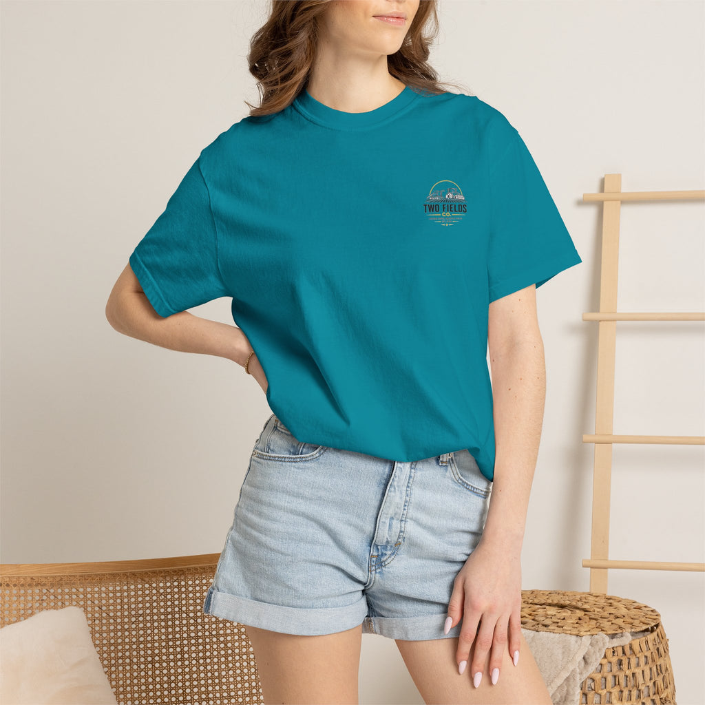Teal t-shirt worn by model with small “Two Fields Co.” chest logo