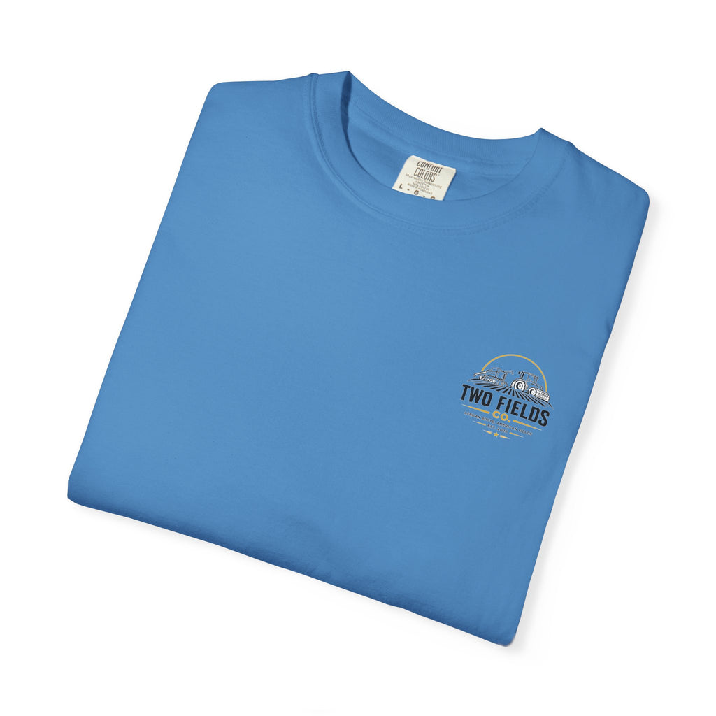 Blue crew-neck T-shirt with small Two Fields Co logo on left chest, flat lay.