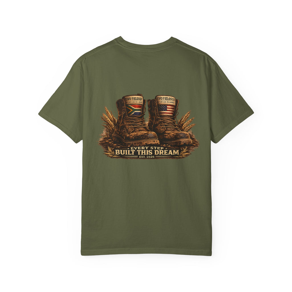 Olive green graphic T-shirt with brown work boots and gold “Every Step Built This Dream”