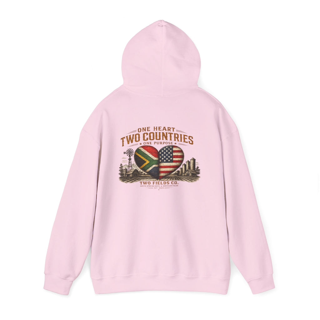 Light pink pullover hoodie with back graphic heart-shaped flags and “Two Countries” text