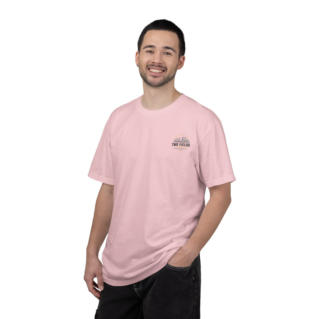 Men's pink crew-neck T-shirt on model with small right-chest 'Two Fields Co.' logo