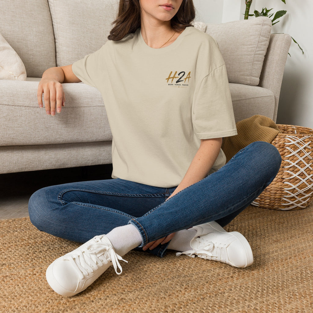 Unisex softstyle t-shirt in beige with small chest logo print, worn