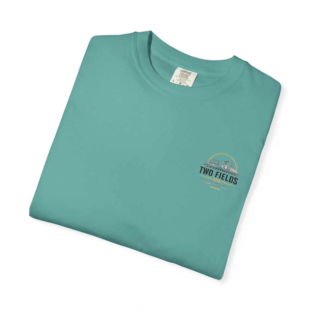 Teal t-shirt folded with small chest “Two Fields Co.” logo