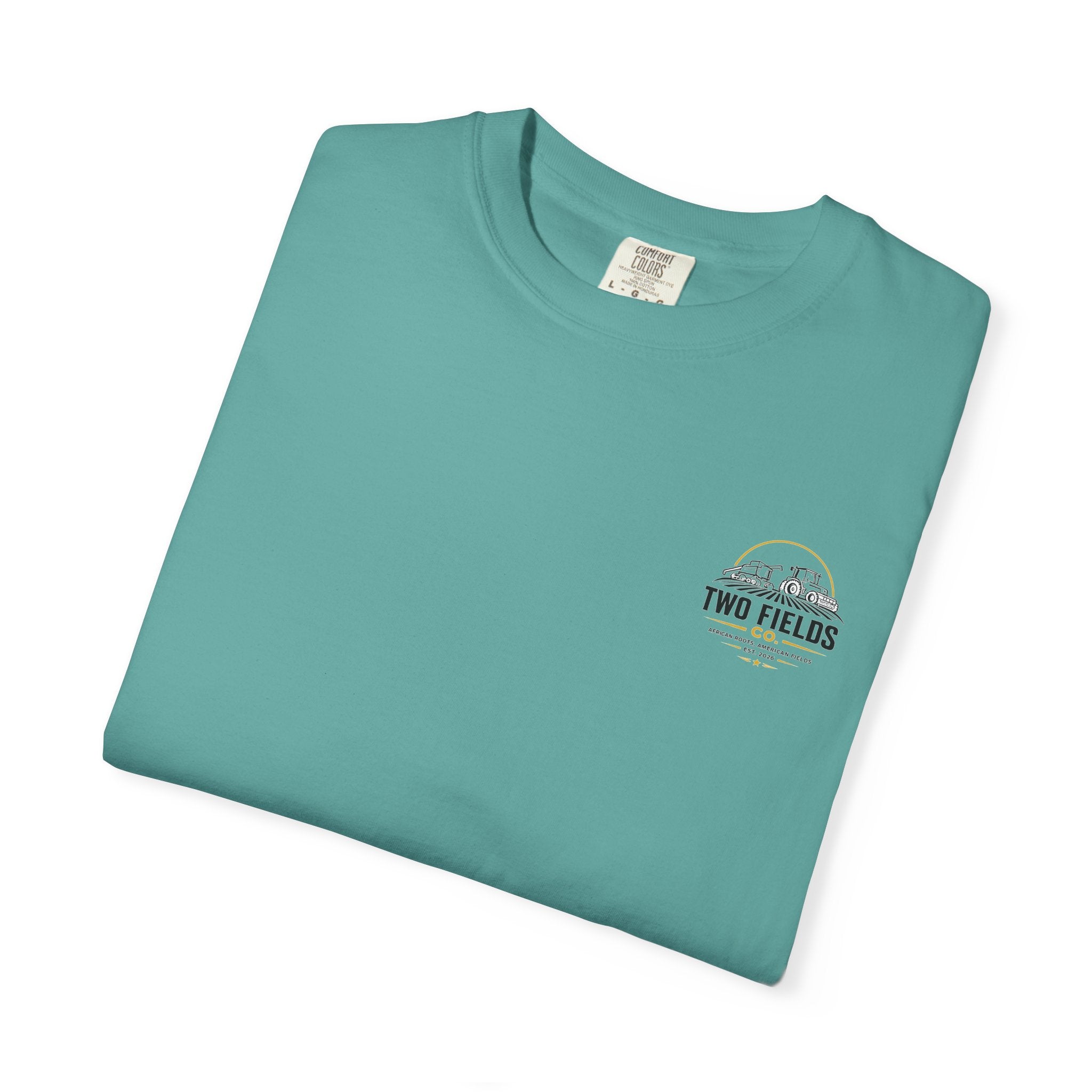 Teal t-shirt folded with small chest “Two Fields Co.” logo