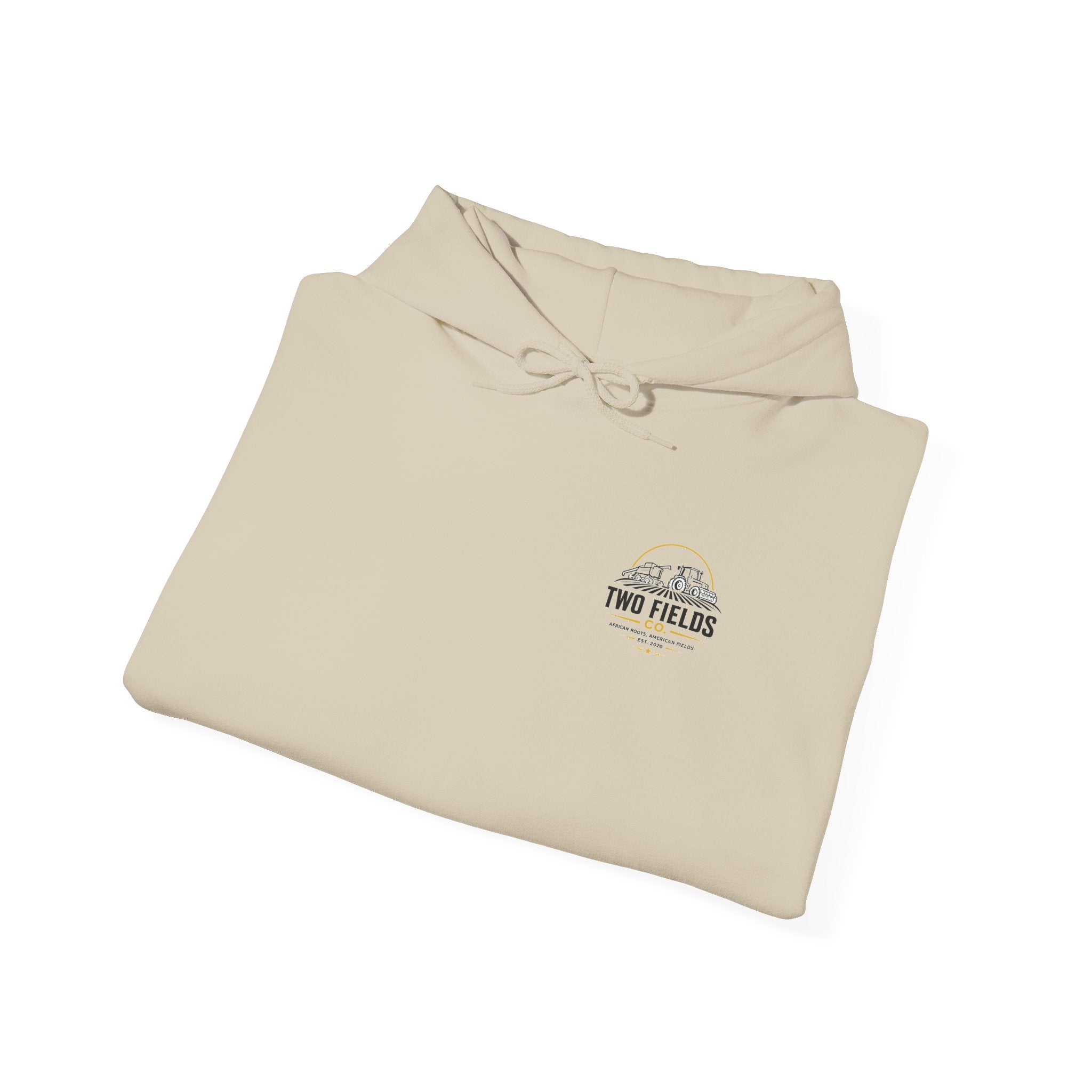 Folded cream hoodie with hood strings and small “TWO FIELDS” emblem