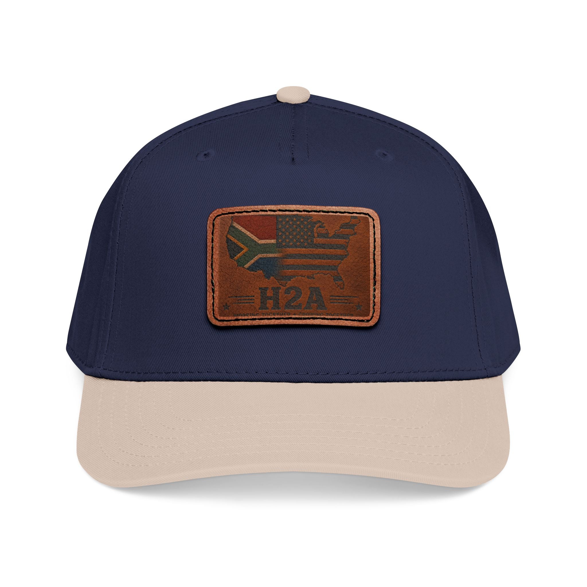 Two-tone baseball cap with rectangular leather patch and H2A flag design, navy and light beige