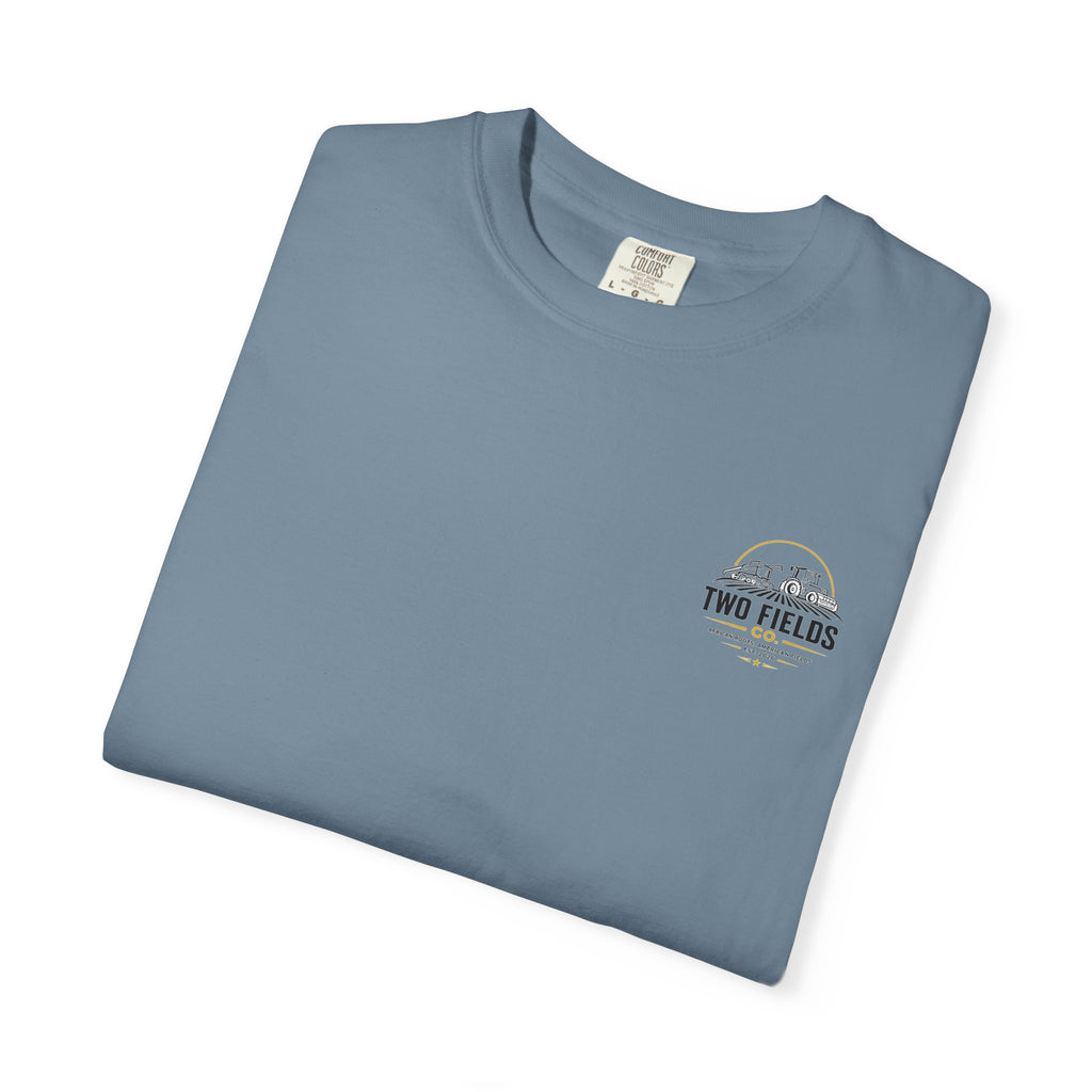 Blue T-shirt folded with small Two Fields Co. logo on chest
