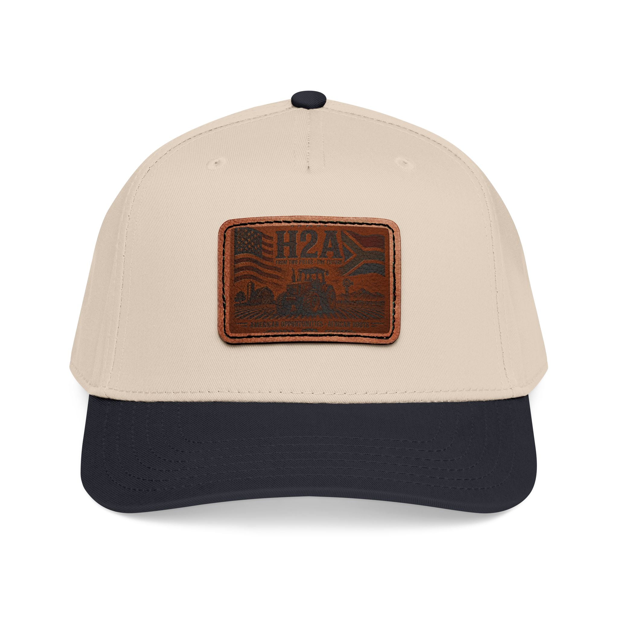 Baseball cap with beige crown, dark navy brim, and light brown rectangle leather logo patch.