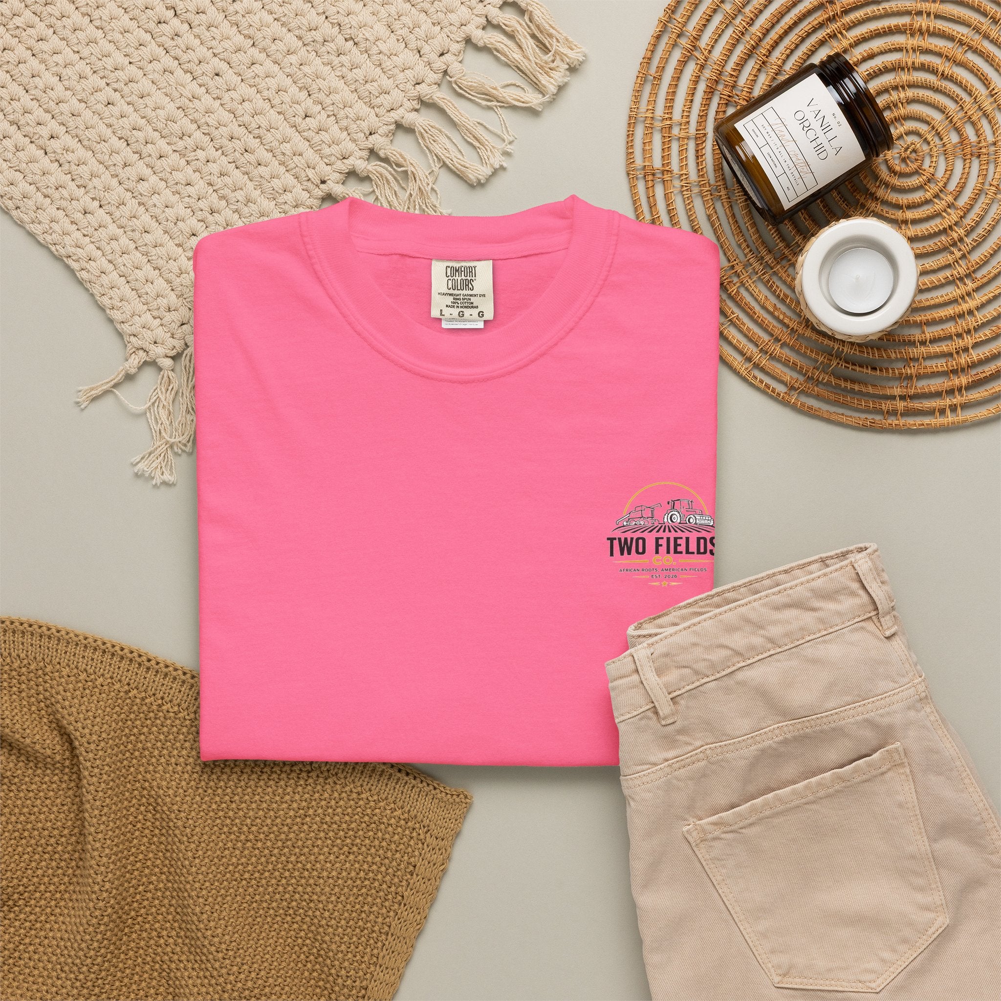 Pink crewneck T-shirt with small Two Fields Co. tractor and family logo