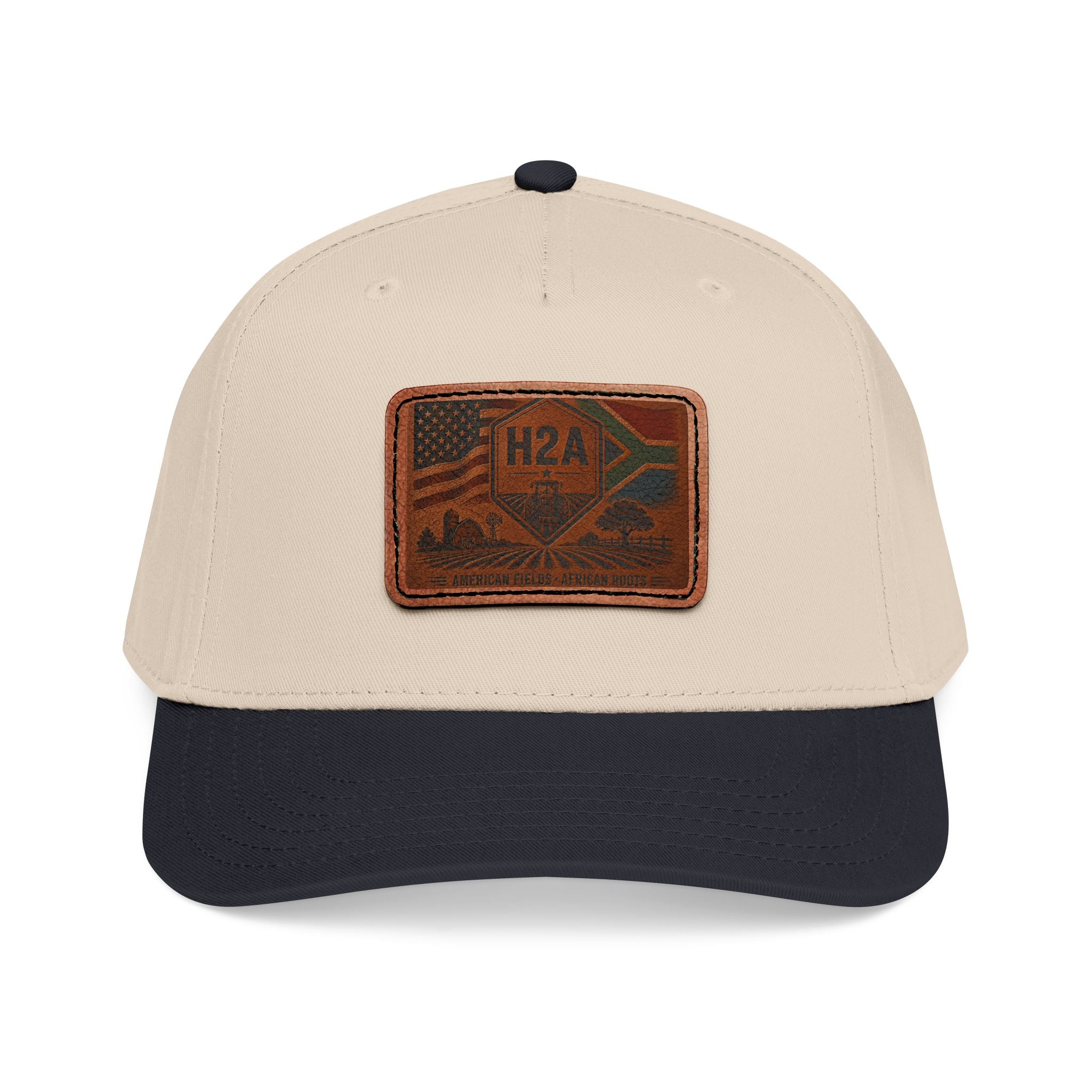 Two-tone baseball cap, tan crown with dark navy brim, rectangular H2A patch