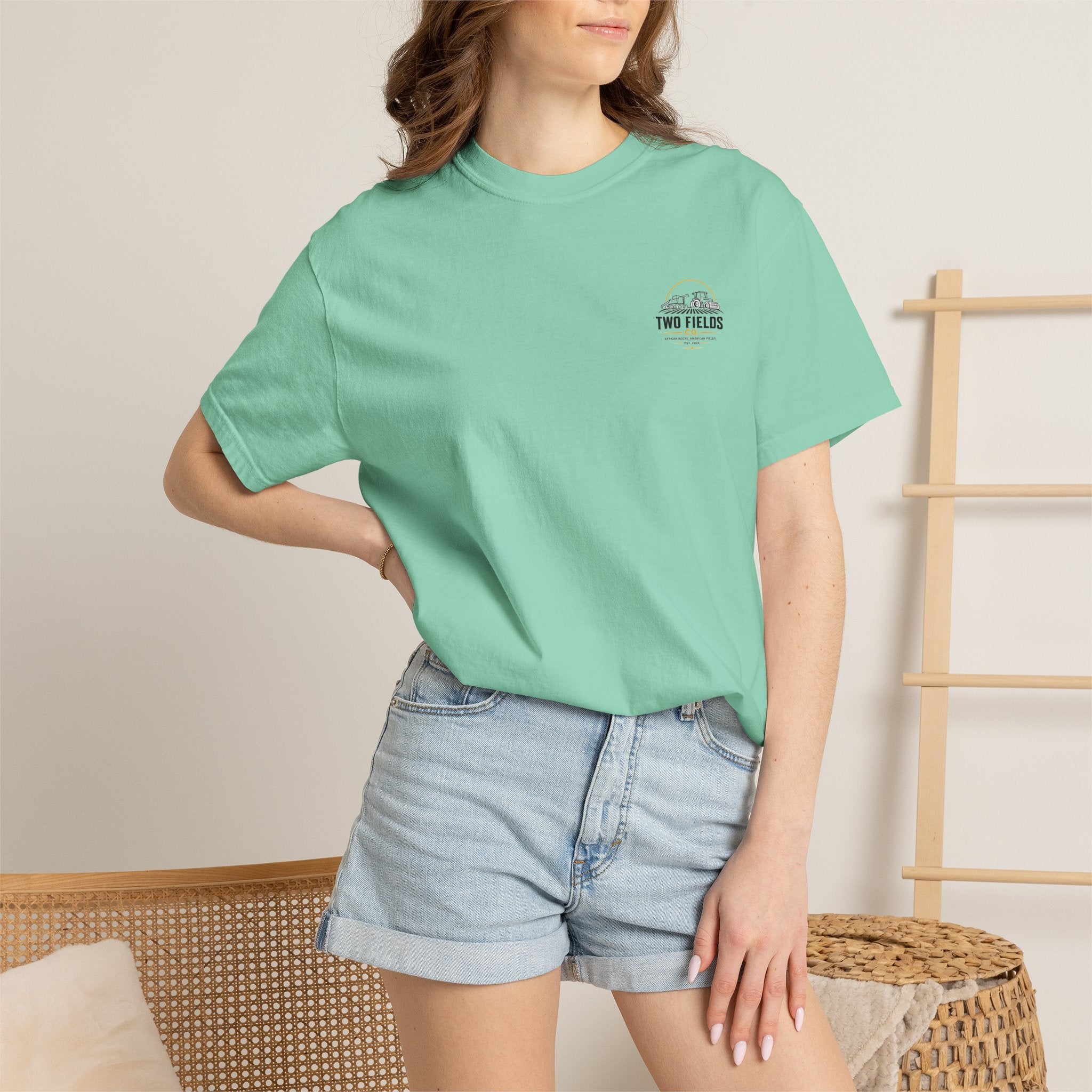 Mint green crew-neck T-shirt being worn, with Two Fields logo on chest