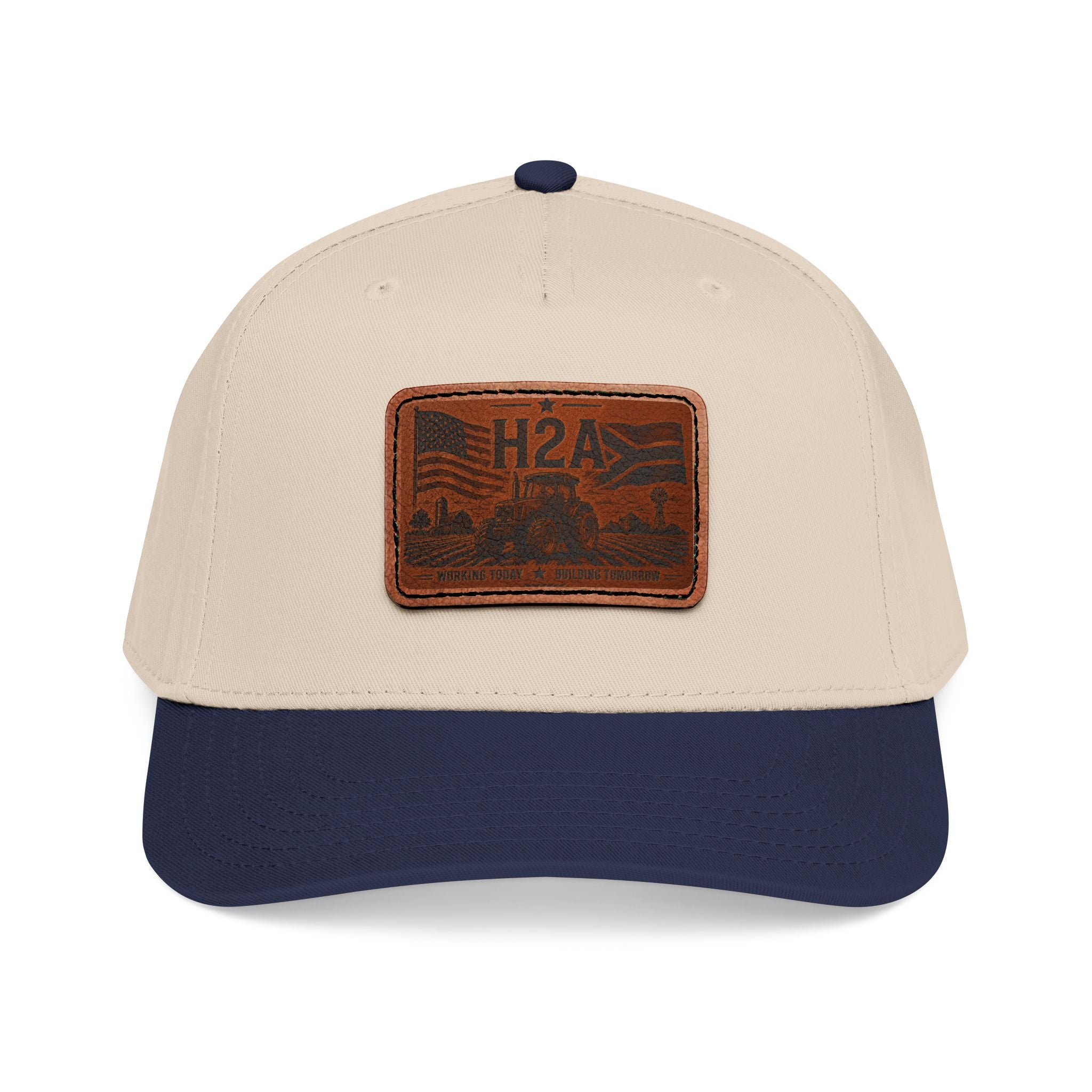 Two-tone baseball cap with rectangle H2A leather patch; beige crown and navy brim.