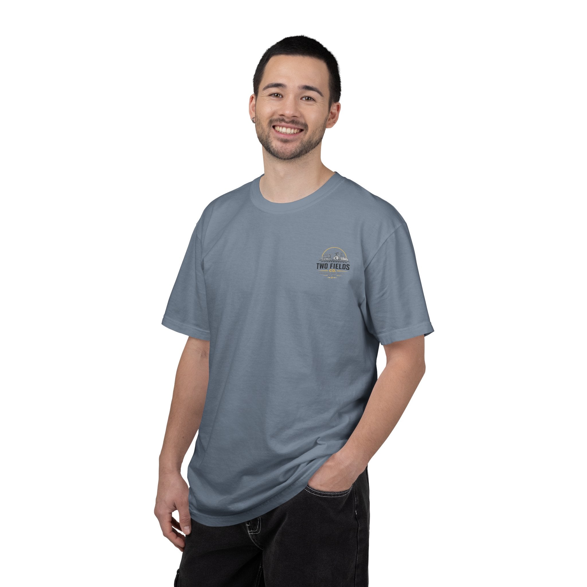 Light blue crewneck T-shirt on model, chest Two Fields Co. tractor logo