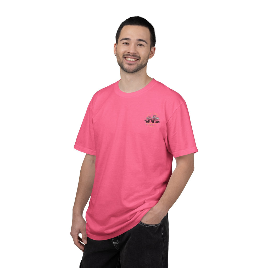 Pink crewneck T-shirt worn by model, small chest tractor and family logo