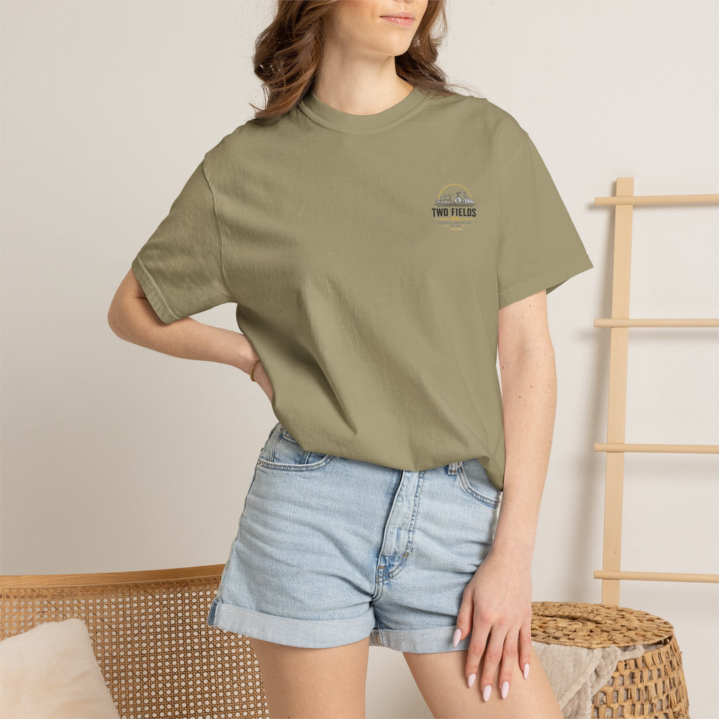 Olive green crewneck graphic T-shirt with small chest logo patch on model