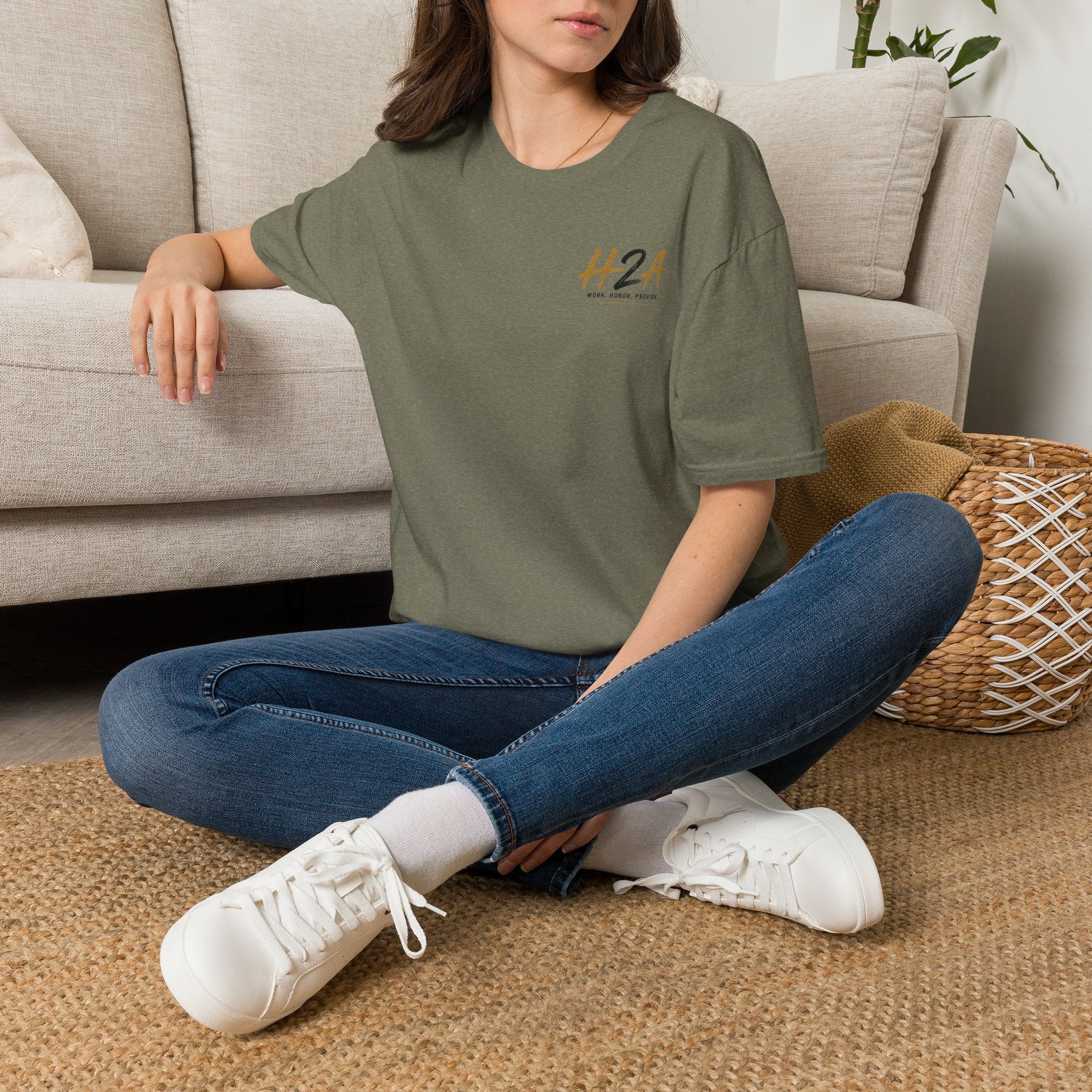 Olive unisex softstyle T-shirt with small chest logo print, worn