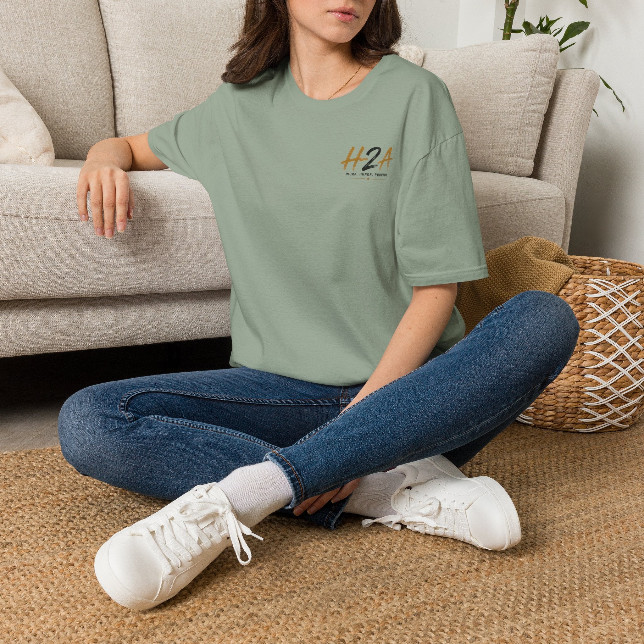 Light green unisex softstyle T-shirt with small chest logo print, worn