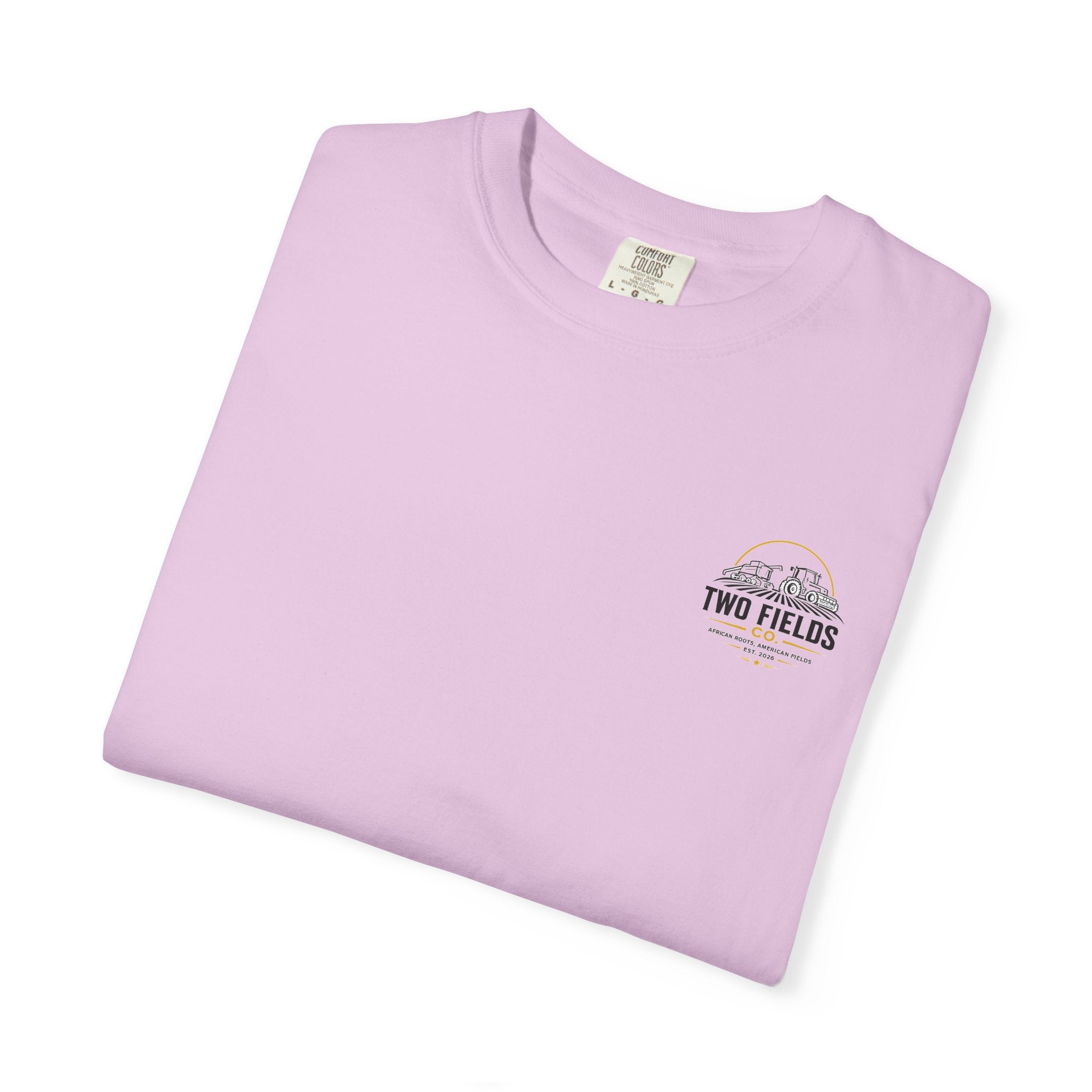 Lilac folded T-shirt with small Two Fields Co. mountain logo on chest
