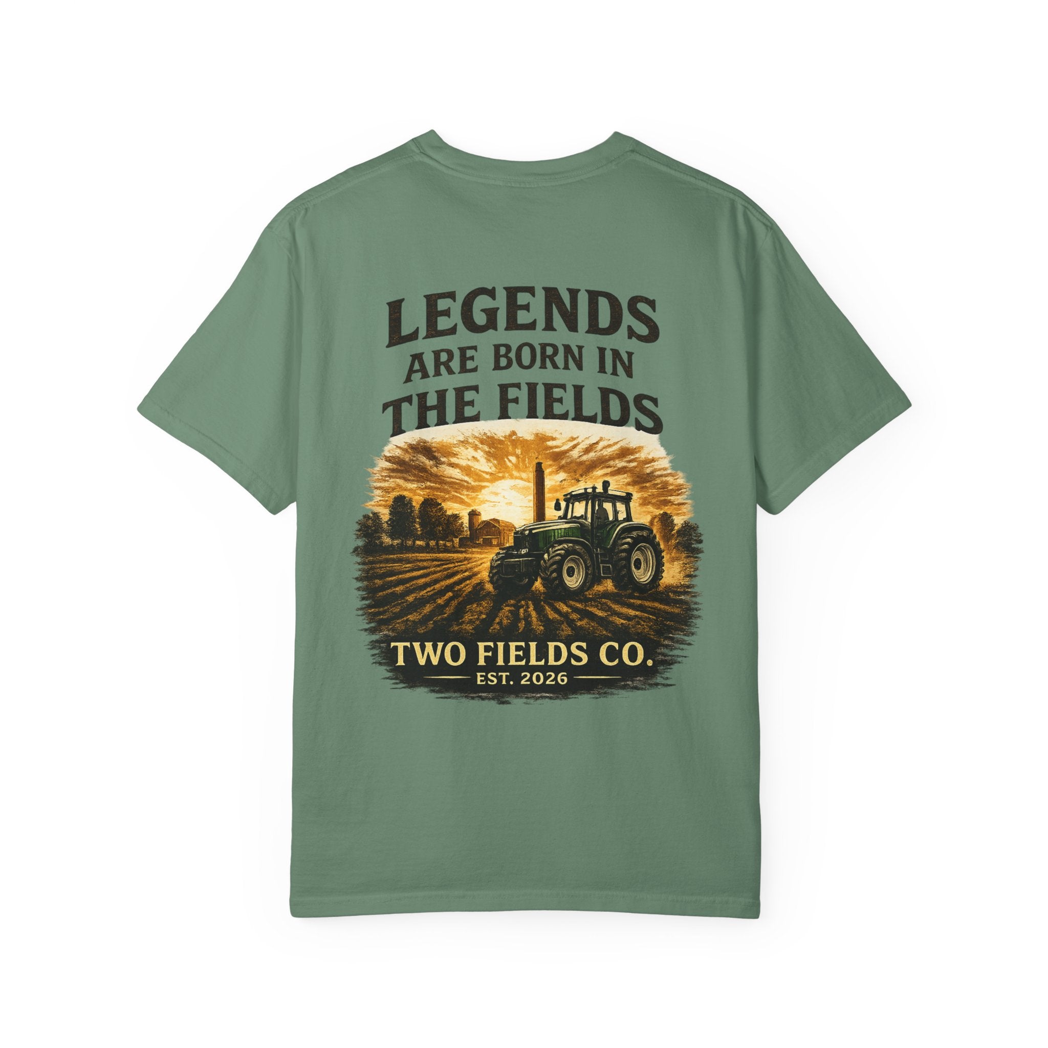 Green T-shirt with front graphic featuring tractor scene and text “TWO FIELDS CO.”