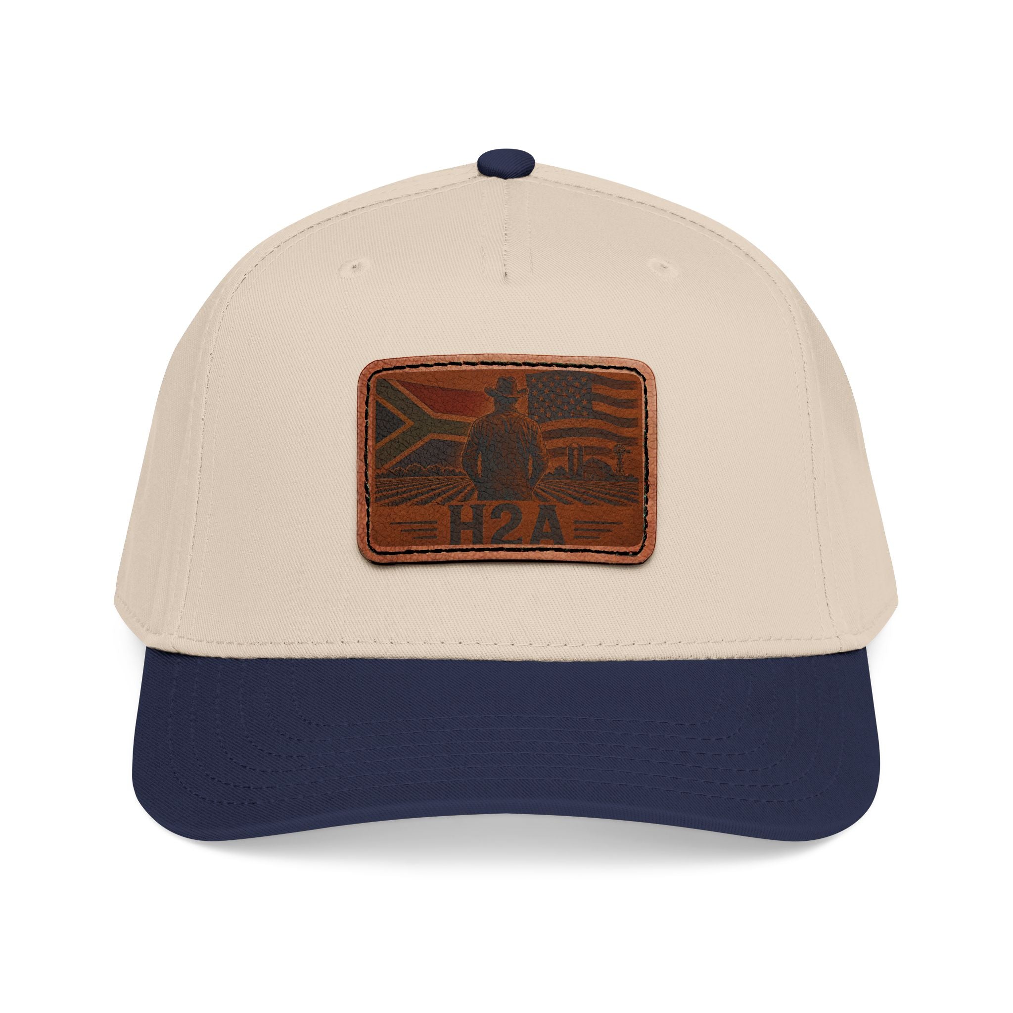Two-tone baseball cap with cream crown, navy brim, and rectangular H2A leather patch.