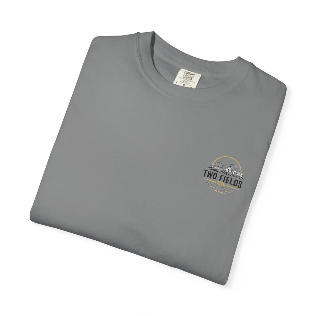 Grey crewneck graphic T-shirt folded, featuring small Two Fields Co. logo on chest.