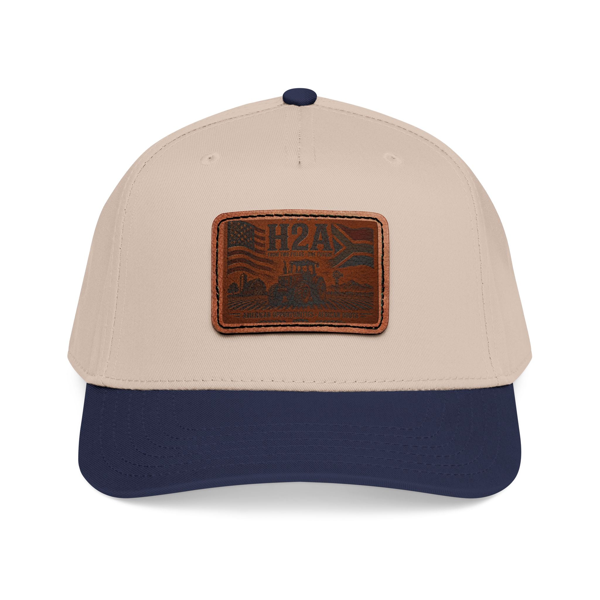 Tan and navy baseball cap with rectangular vintage logo leather patch on front