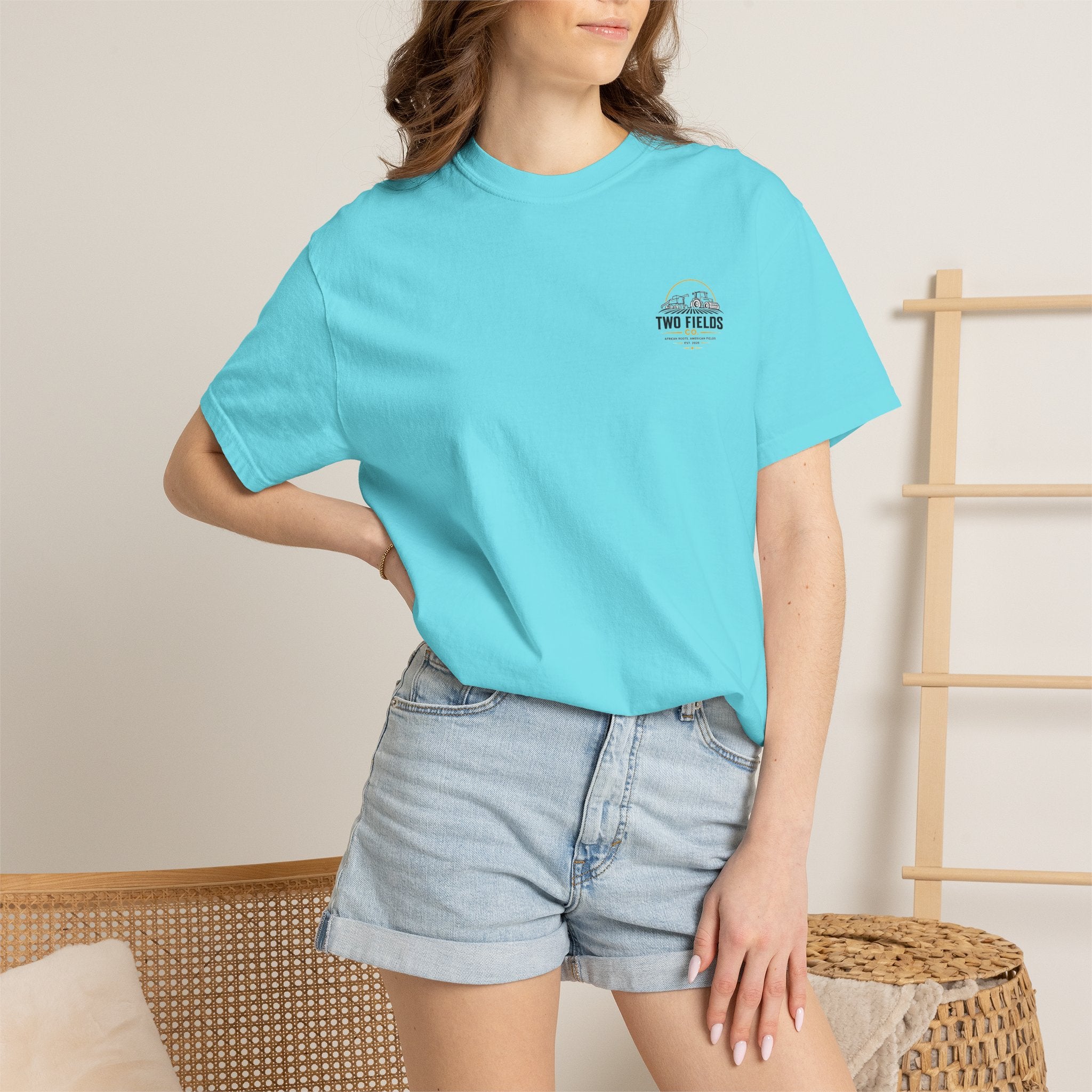 Two Fields tractor T-shirt, turquoise, worn by model, small chest logo
