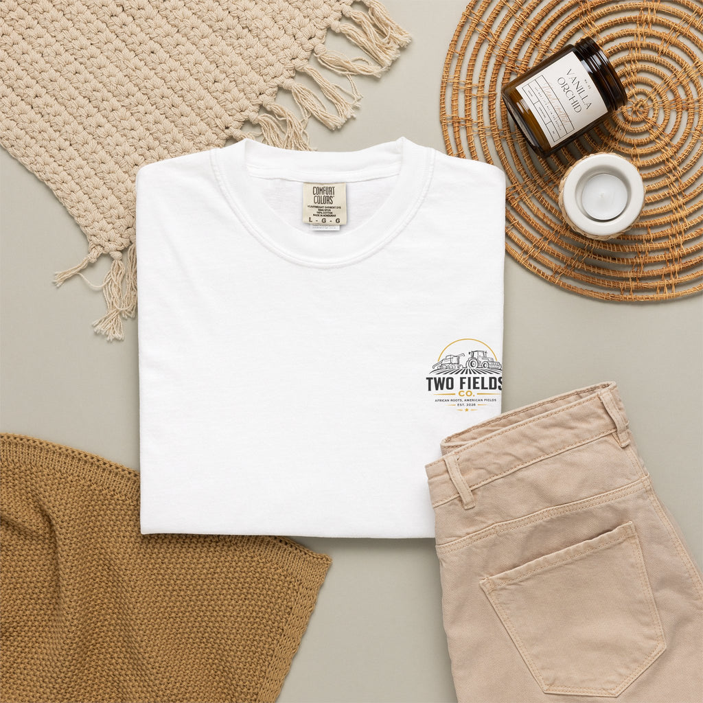 White family farm graphic T-shirt with small tractor logo on chest, folded view