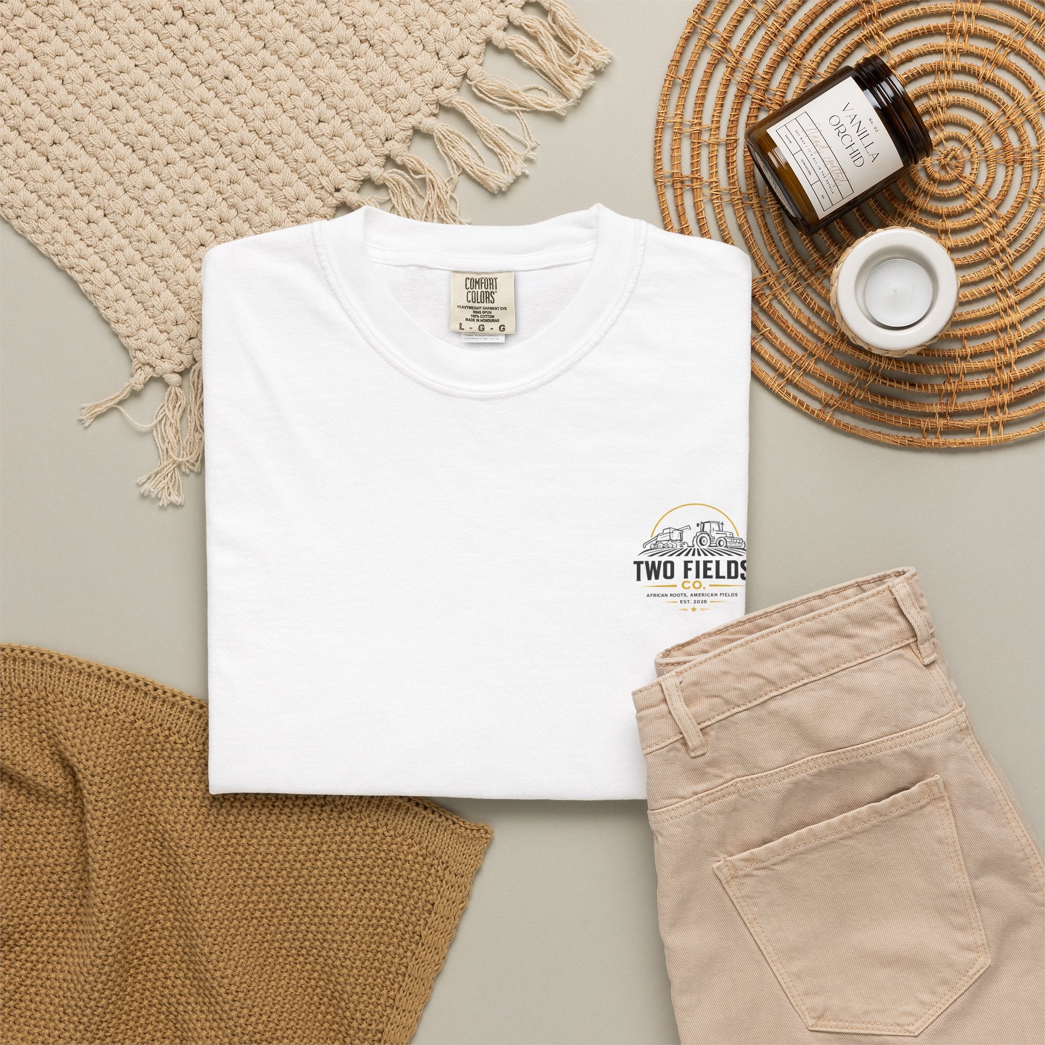 White family farm graphic T-shirt with small tractor logo on chest, folded view